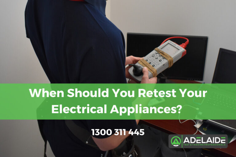 Technician using a portable appliance tester on electrical equipment, with text overlay "When Should You Retest Your Electrical Appliances?" and contact number, relevant to Portable Appliance Testing services in Adelaide.